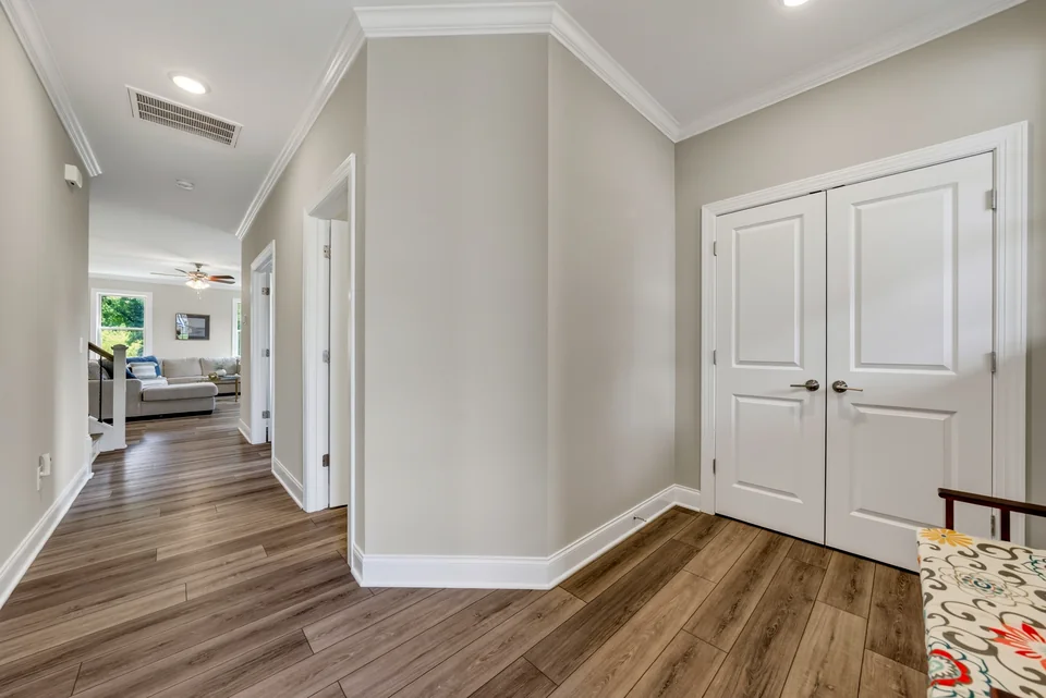 Hallway with wood floors and white doors
