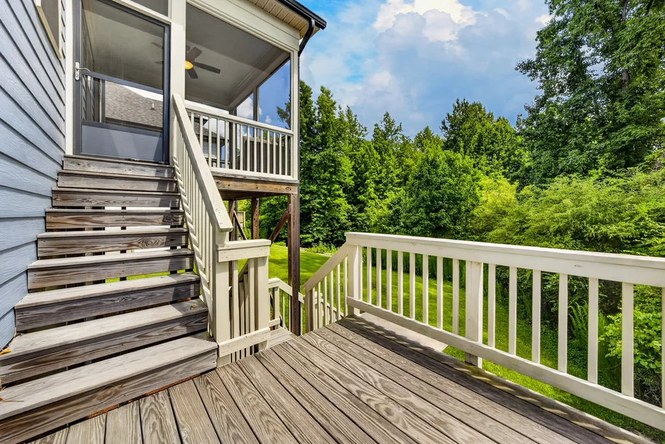 Rear deck and exterior stairs overlooking trees