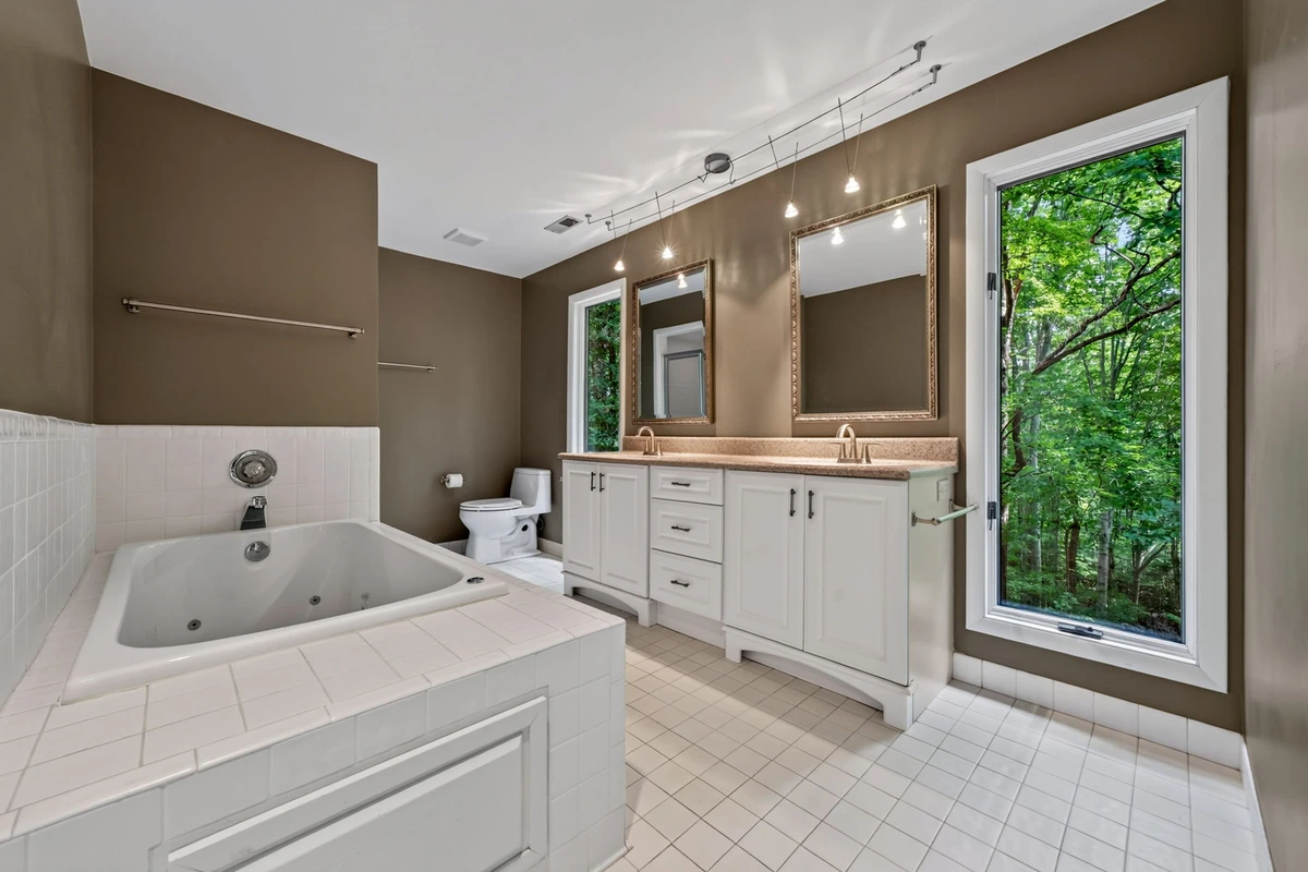 Bright Garner bathroom with glass shower and double vanity