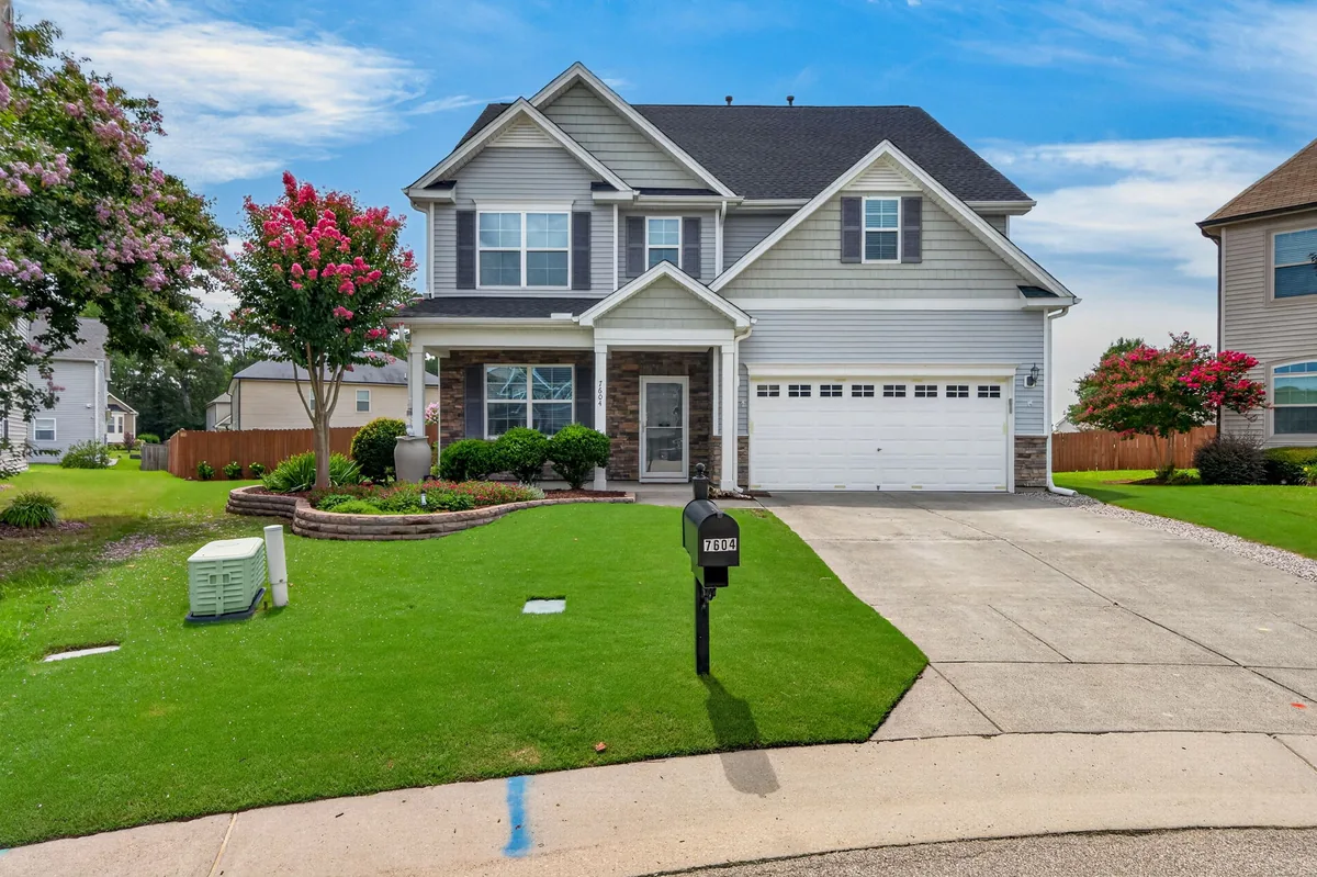 Front exterior of a two-story Raleigh home with a landscaped entry