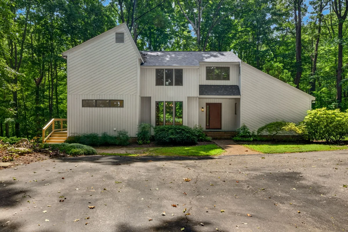 Front exterior of a contemporary Garner home surrounded by trees