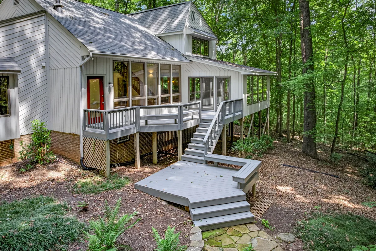 Rear exterior and elevated deck of a wooded Garner property