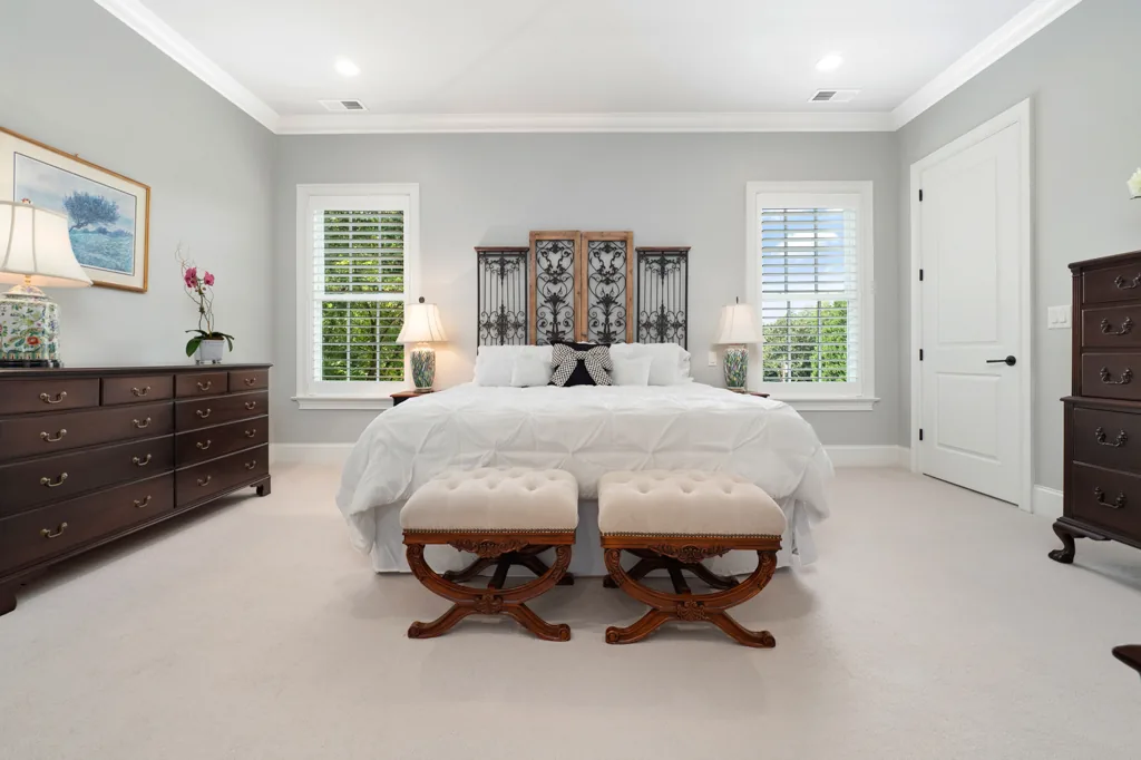Peaceful, thoughtfully prepared bedroom with a neatly made bed and clear nightstands