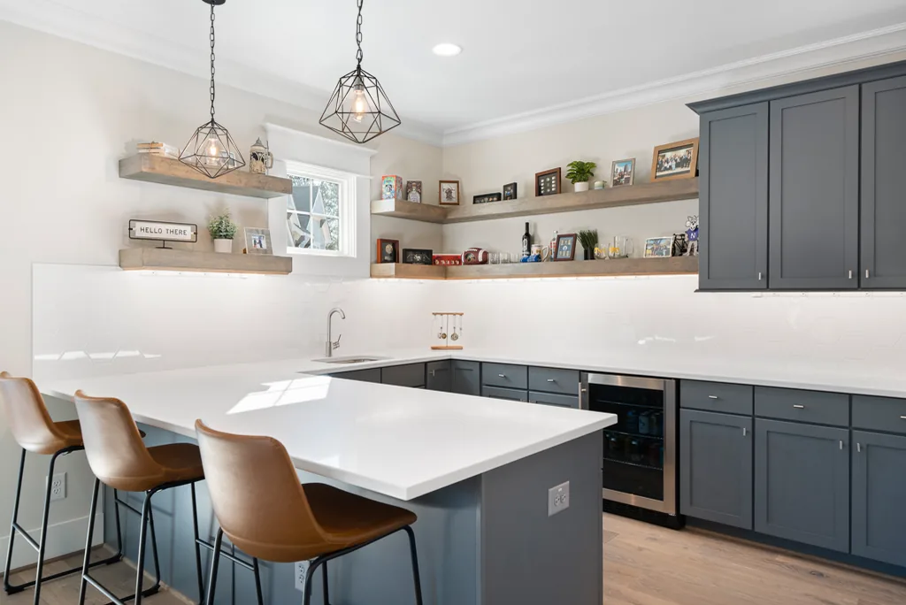 Clean, welcoming kitchen with clear countertops and neatly arranged seating