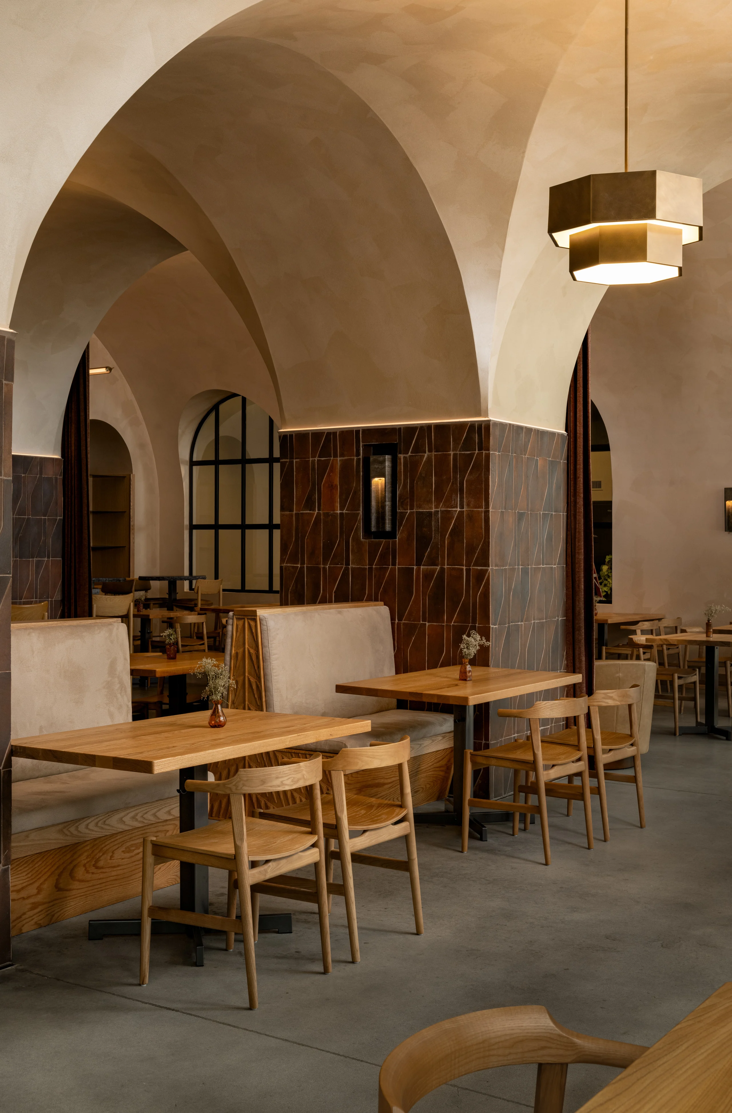 Vaulted hospitality dining room with arched openings and carefully detailed seating