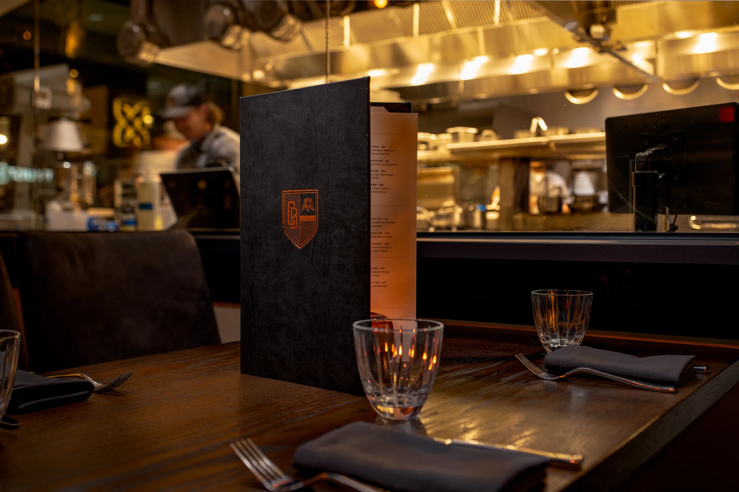 Hospitality table setting and kitchen detail photographed in warm ambient light